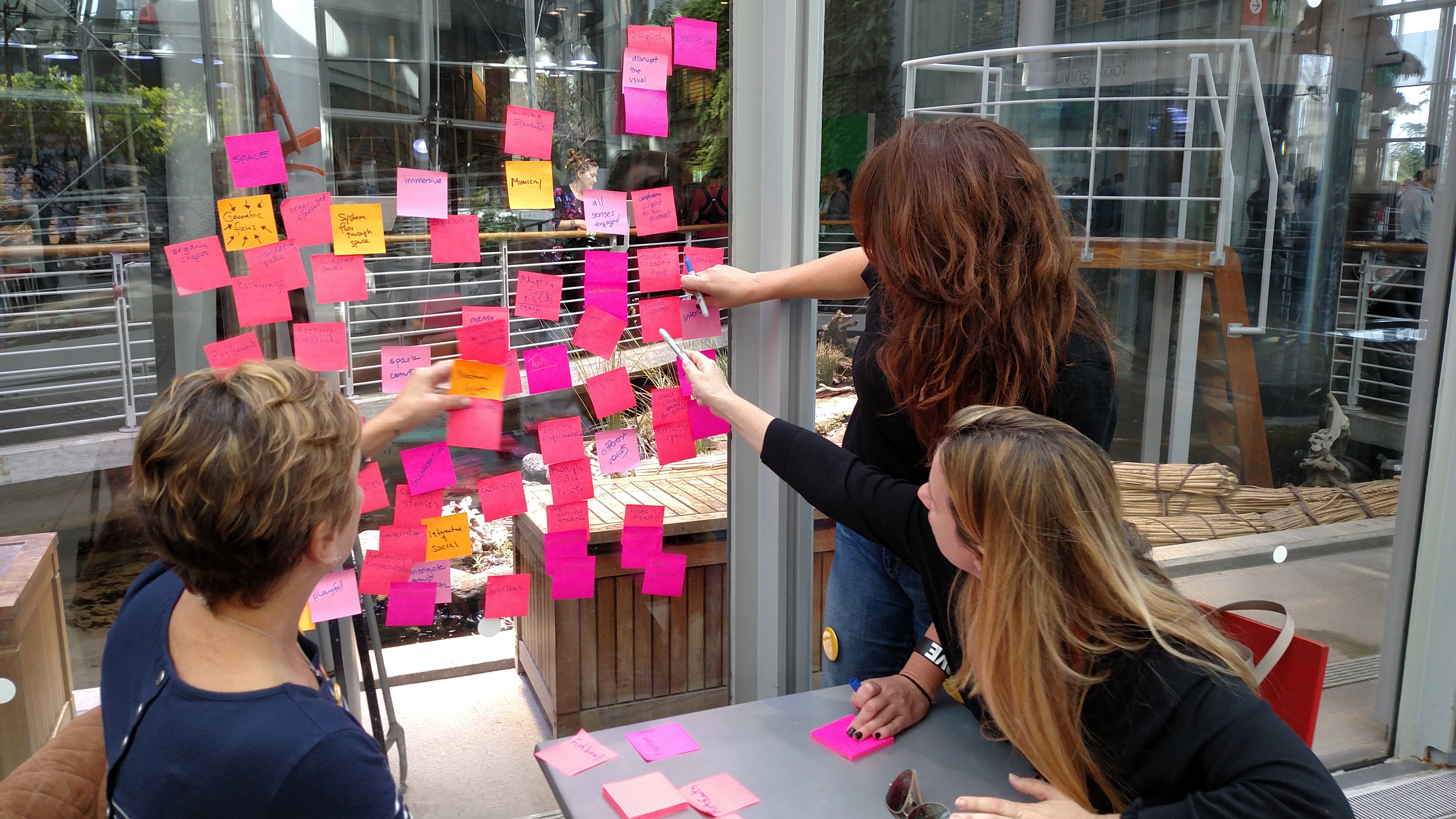 Educators collaborating with sticky notes during a design-thinking workshop.